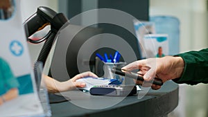 Elderly person paying medicaments and drugs with telephone and nfc