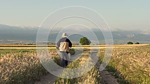 Elderly pilgrim walking on famous pilgrimage route of camino de Santiago, Spain.