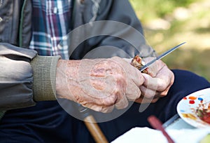 Elderly poor man eating bread