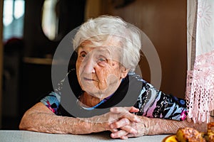 An elderly powoman at the dinner table. ConversationÑŽ