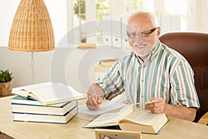 Elderly professor working in his study