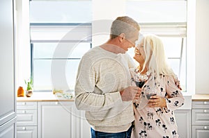 Elderly retired couple sharing a tender moment