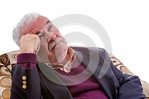 Elderly retired man relaxing in a chair