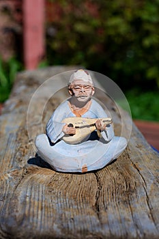 Elderly sage plays a musical instrument