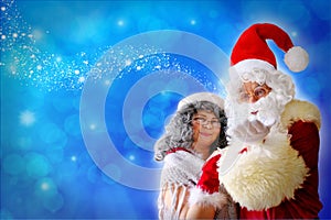 Elderly santa claus with his wife congratulates children and adults, shows with hands, concept of christmas, childhood, festive