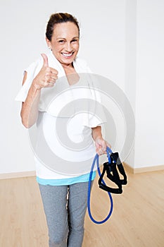 Elderly senior with skipping rope and thumb up