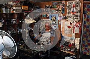 Elderly shoe repairman in his workshop