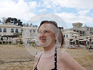 Elderly smiling woman on the beach, portrait