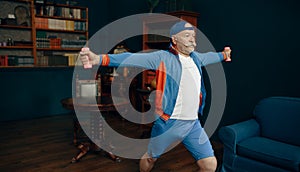 Elderly sportsman doing exercise with dumbbells