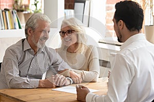 Elderly spouses during meeting with banker or real estate agent