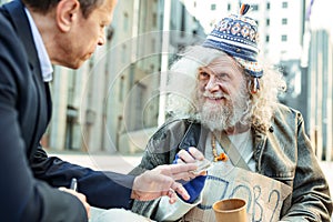 Elderly street musician feeling thankful