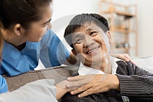 elderly touch hand on back of hand caregiver or nurses to express thankful