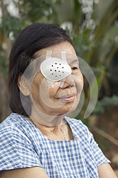 Elderly use eye shield covering after cataract surgery.