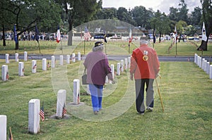 Elderly Veteran and Wife in Cemetery