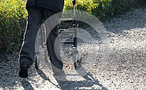 Elderly with a Walker during the walk in the Park