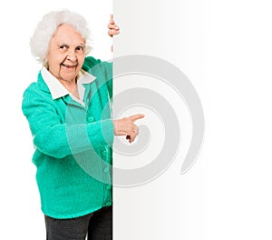 Elderly woman alongside of ad board