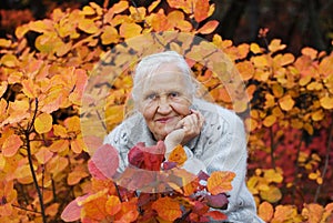 Elderly woman at the autumn background