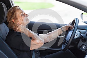 Elderly woman behind the steering wheel