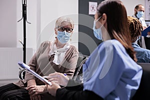 Medium shot of patient at busy clinic, medical consultation