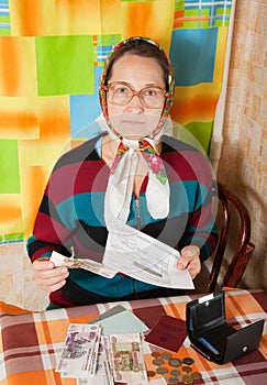 Elderly woman with bill and money