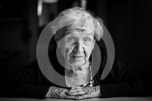 An elderly woman. Black-and-white close-up portrait.