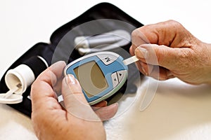 Elderly woman with blood sugar monitoring