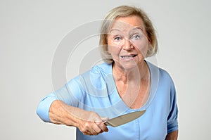 Elderly woman brandishing a kitchen knife