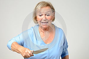 Elderly woman brandishing a kitchen knife