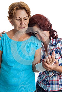 Elderly woman with a broken arm and her caregiver