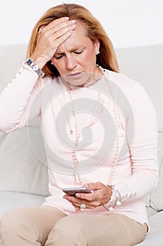 Elderly woman calling the doctor