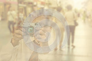 Elderly woman with camera. Double exposure image with unrecogni