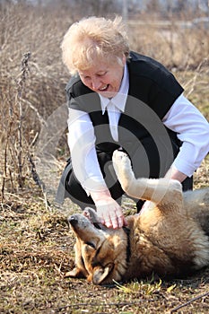 Elderly woman caresses dog