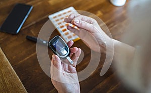 Elderly woman checking her blood sugar level