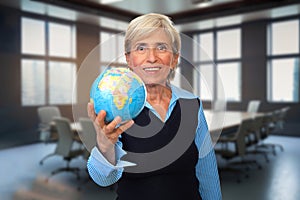 Elderly Woman in the Conference Room with the Globe in Her Hand