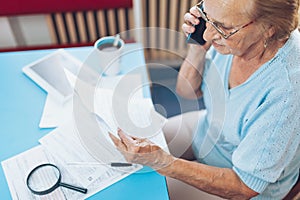 Elderly woman contacting custumer services after recieving a bill