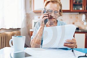 Elderly woman contacting custumer services after recieving a bill