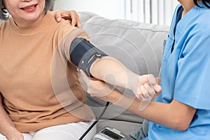 An elderly woman with a contented life having a blood pressure check.