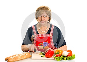 Elderly woman cooks food