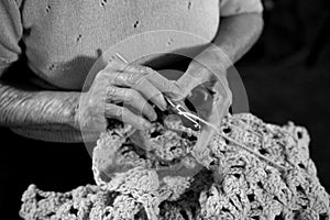 Elderly Woman Crocheting a Baby Blanket