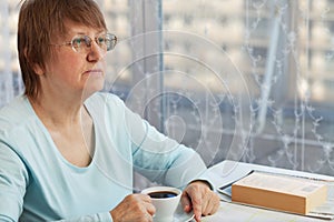 Elderly woman with a cup of coffee