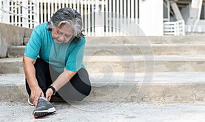 Elderly woman, is currently having a Ankle injury during her exercise by running in the stairs