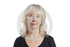 Elderly woman. Cute blonde woman with a neutral expression wearing a black sweater. Close-up. Isolated on a white background