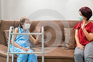 Elderly woman and daughter keeping distance to prevent covid-19