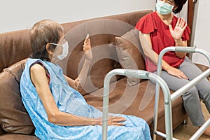 Elderly woman and daughter keeping distance to prevent covid-19