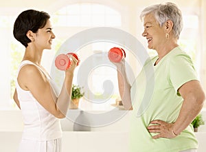 Elderly woman doing dumbbell exercise