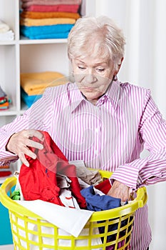 Elderly woman doing laundry