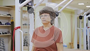 Elderly woman doing physiotherapy exercises in fitness room. Healthy gymnastics. Active seniors.