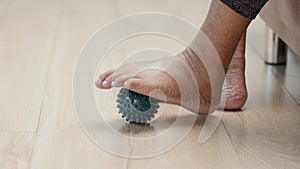 Elderly woman doing rubber ball for exercise fingers, palm ,hand and foot muscle with caregiver take care