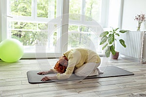 Elderly woman doing yoga practice