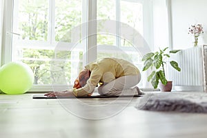 Elderly woman doing yoga practice